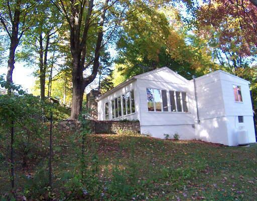 668 Redding Road Redding, CT 06896 - Photo 1 of 1 a front view of a house with a yard and large trees