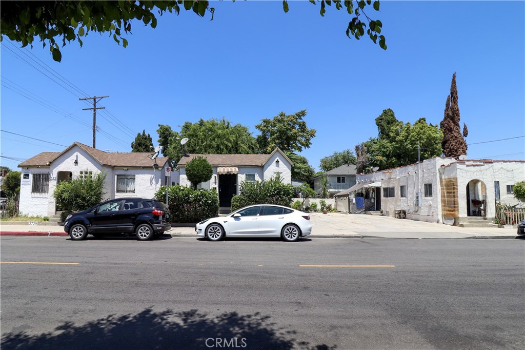 2705 Trinity Street Los Angeles, CA 90011 - Photo 4 of 7 a car parked in front of a house