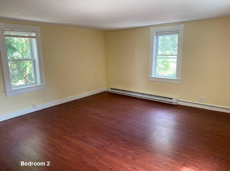 227 Bridge Street, Unit 3 Northampton, MA 01060 - Photo 17 of 19 a view of a room with wooden floor and windows in it