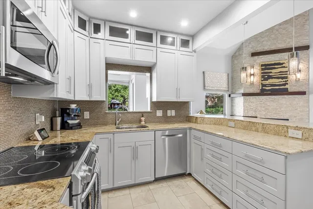 a kitchen with a sink stove and cabinets