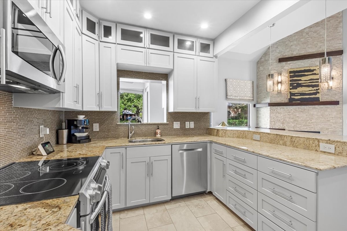 4144 Greystone Way, Unit 303 Sugar Land, TX 77479 - Photo 2 of 33 a kitchen with a sink stove and cabinets