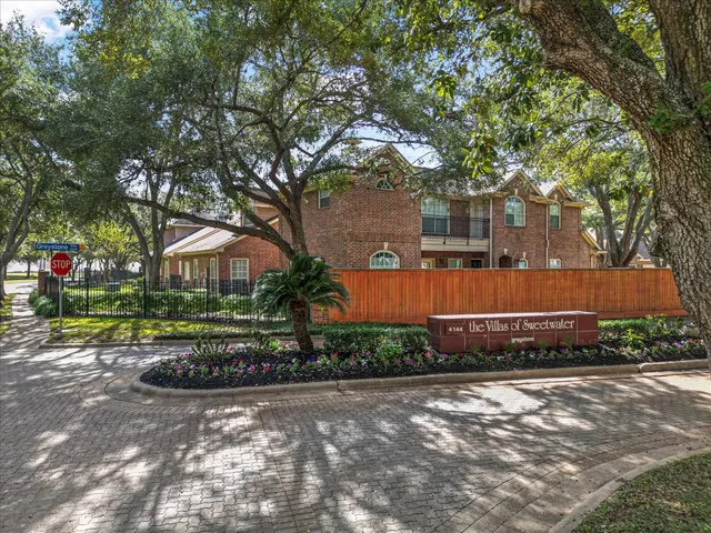 a view of a house with swimming pool and a yard