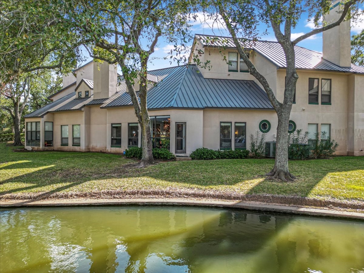 4144 Greystone Way, Unit 303 Sugar Land, TX 77479 - Photo 22 of 33 a view of a house with swimming pool and a yard