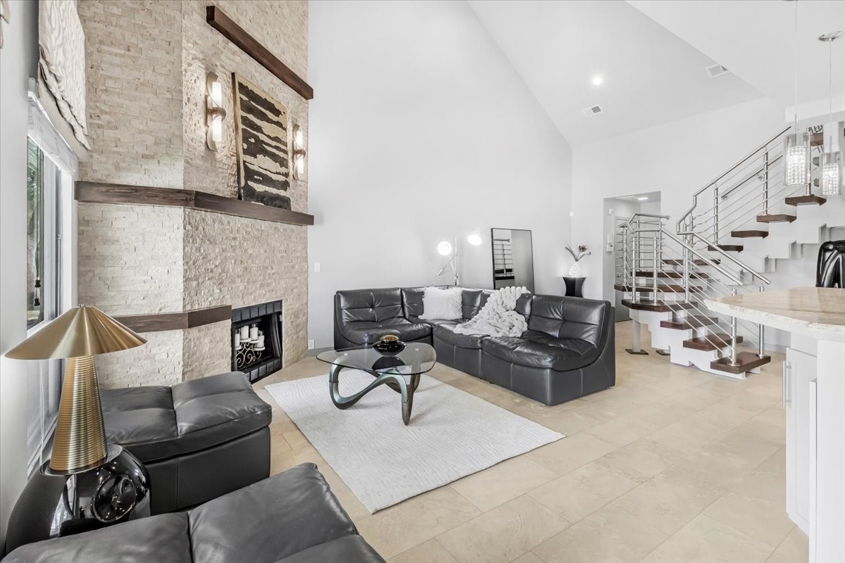 4144 Greystone Way, Unit 303 Sugar Land, TX 77479 - Photo 29 of 33 a living room with furniture and a fireplace