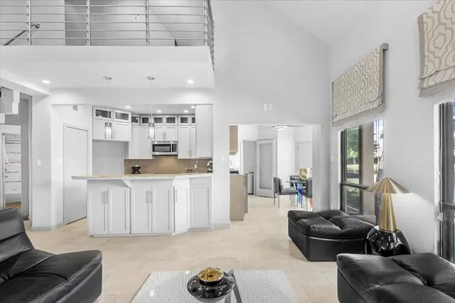 a living room with furniture and kitchen view