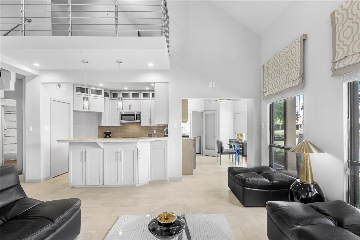 4144 Greystone Way, Unit 303 Sugar Land, TX 77479 - Photo 30 of 33 a living room with furniture and kitchen view