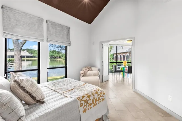 a bedroom with furniture and a large window