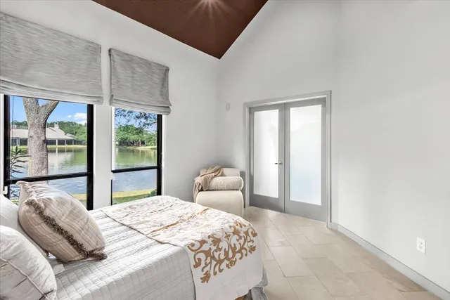 a bedroom with a bed and large window