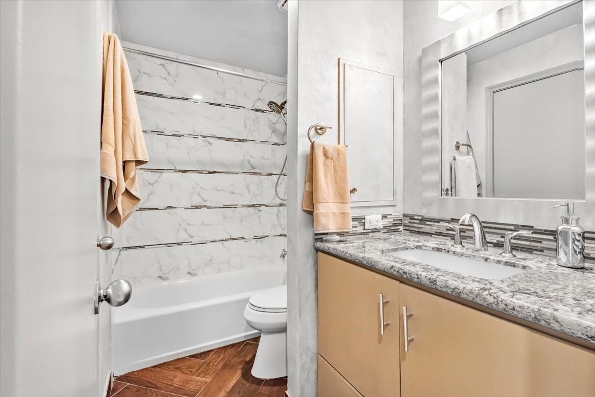 4144 Greystone Way, Unit 303 Sugar Land, TX 77479 - Photo 10 of 33 a bathroom with a granite countertop sink toilet and shower