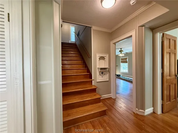 a view of entryway and hall with wooden floor