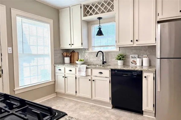 a kitchen with stainless steel appliances a refrigerator sink and cabinets
