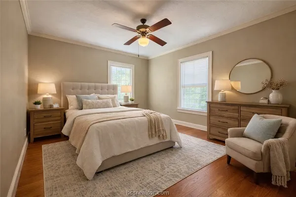 a bedroom with bed couch and window