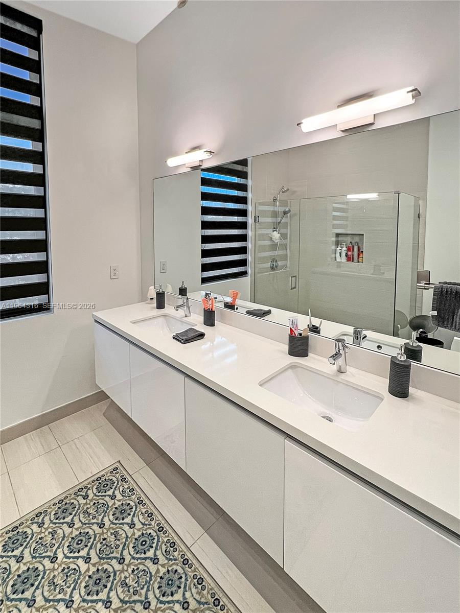 16640 Sunset Way Weston, FL 33326 - Photo 21 of 35 a bathroom with a sink and a mirror