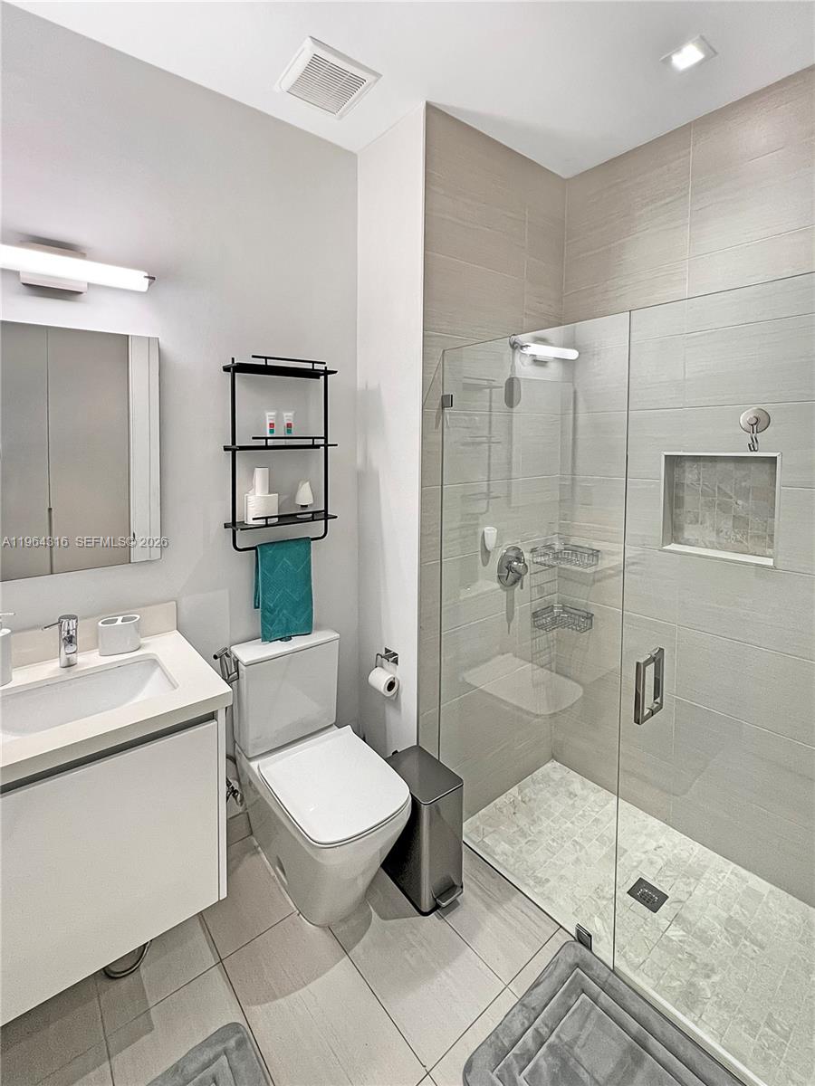 16640 Sunset Way Weston, FL 33326 - Photo 23 of 35 a bathroom with a sink a toilet and shower