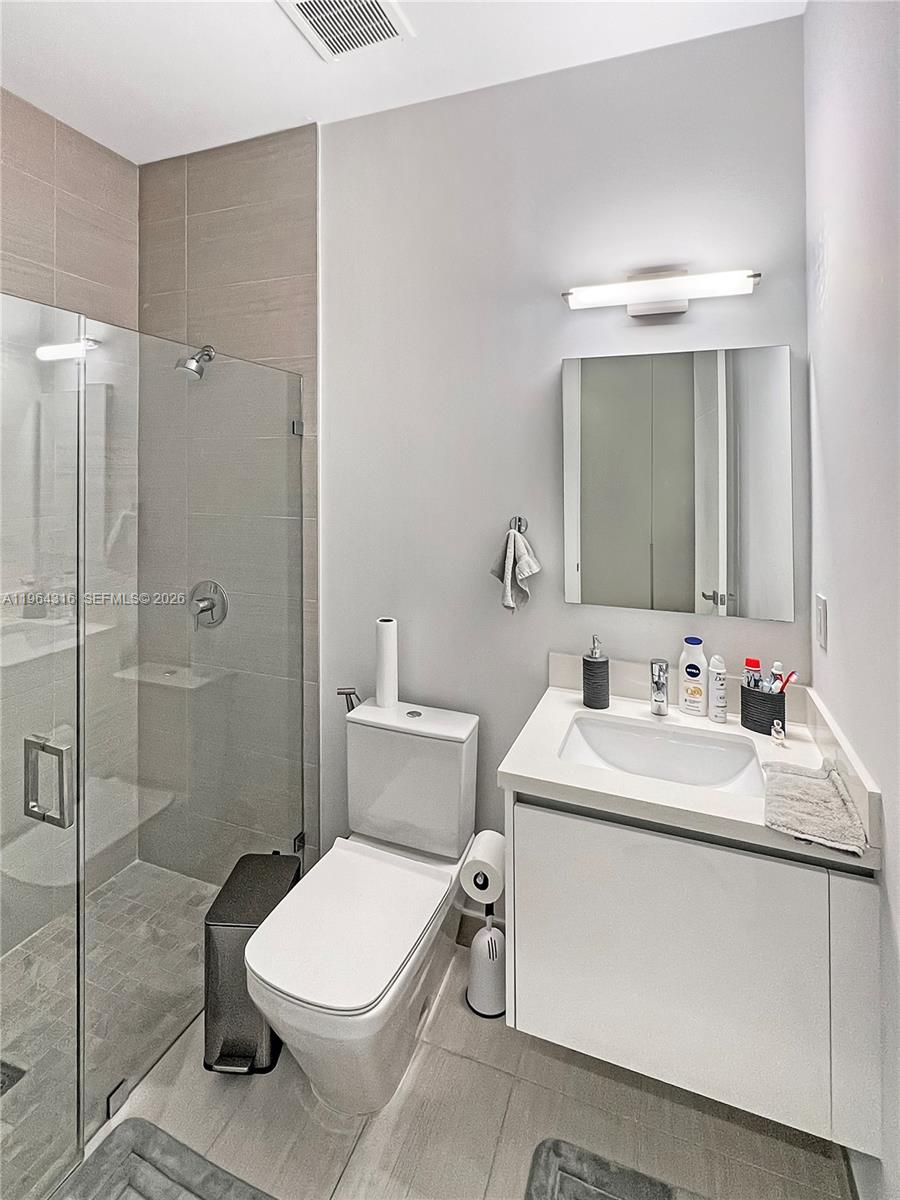 16640 Sunset Way Weston, FL 33326 - Photo 25 of 35 a bathroom with a toilet sink and shower