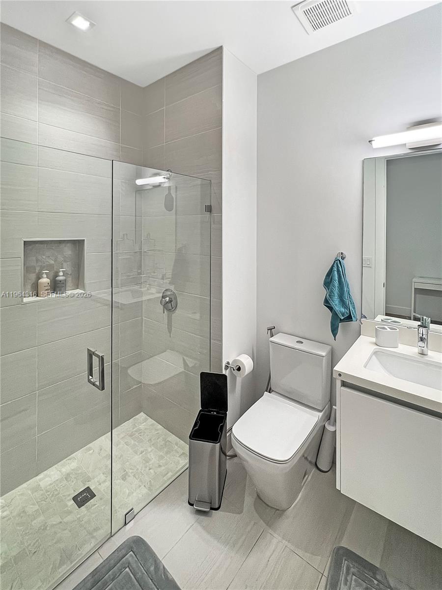 16640 Sunset Way Weston, FL 33326 - Photo 27 of 35 a bathroom with a toilet sink and shower