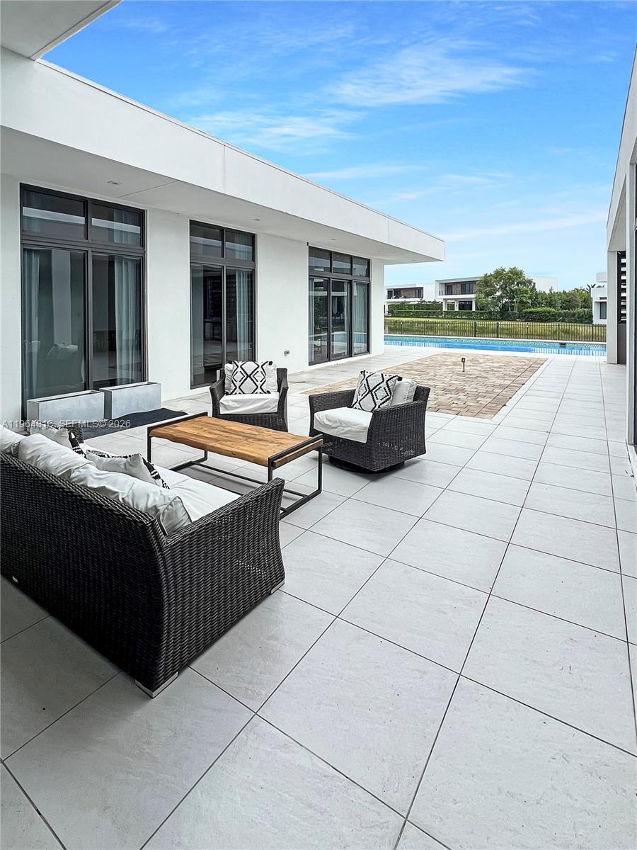 16640 Sunset Way Weston, FL 33326 - Photo 29 of 35 a outdoor space with patio furniture and a garden