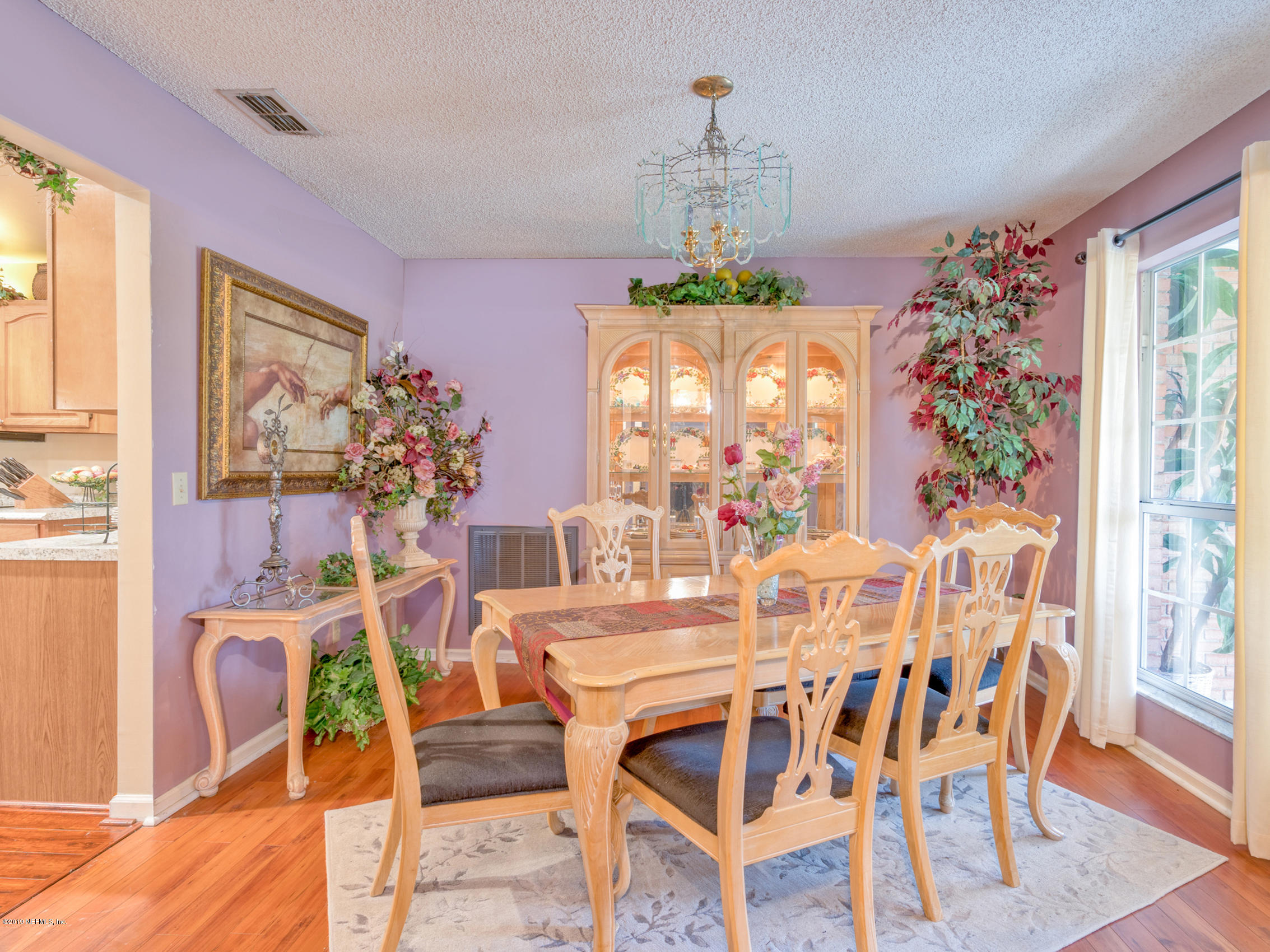 54201 Church Road Callahan, FL 32011 - Photo 4 of 37 a view of a dining room with furniture a chandelier and wooden floor