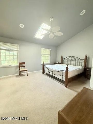 a living room with a bed furniture and a window