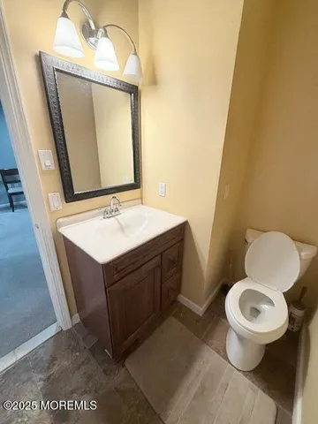 a bathroom with a toilet a sink and mirror