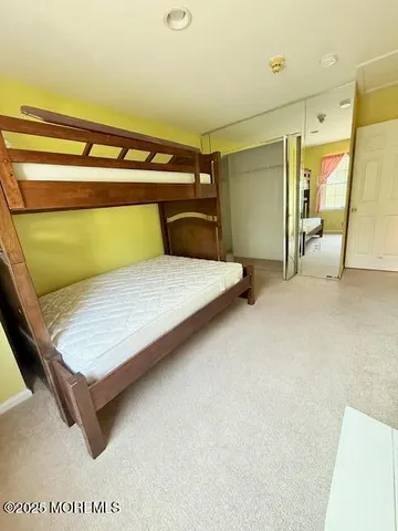 a bedroom with a bed and walk in closet