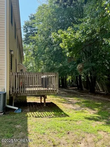 a view of swimming pool with deck and garden
