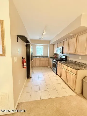 a large kitchen with cabinets and a stove