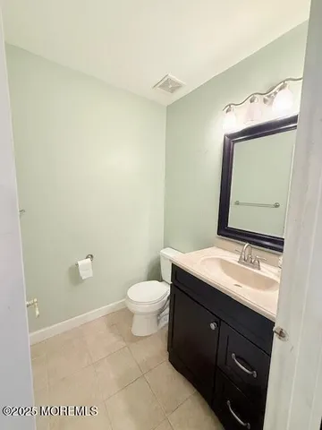 a bathroom with a granite countertop sink mirror and toilet