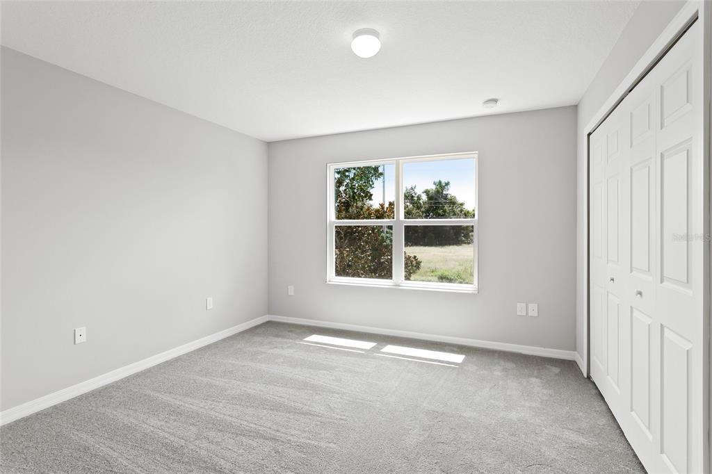 591 Pacito Way St. Cloud, FL 34769 - Photo 16 of 28 an empty room with windows and closet