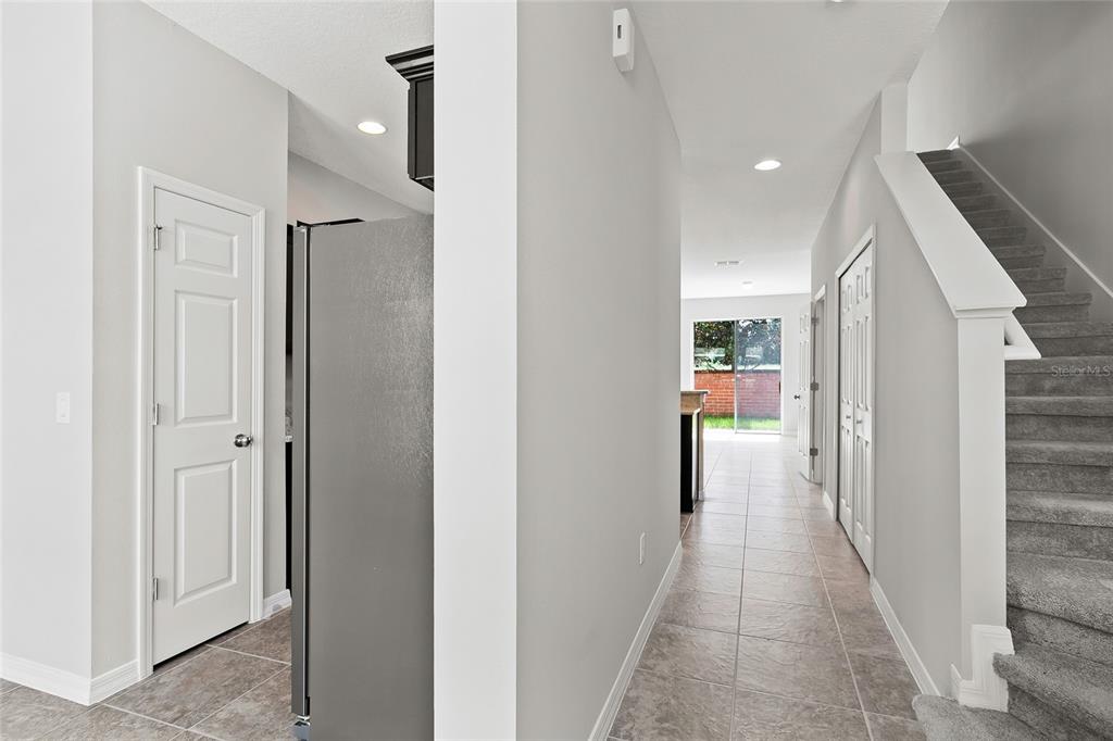 591 Pacito Way St. Cloud, FL 34769 - Photo 2 of 28 a view of a hallway with wooden shelves