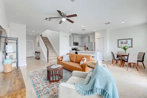 a living room with furniture and kitchen view