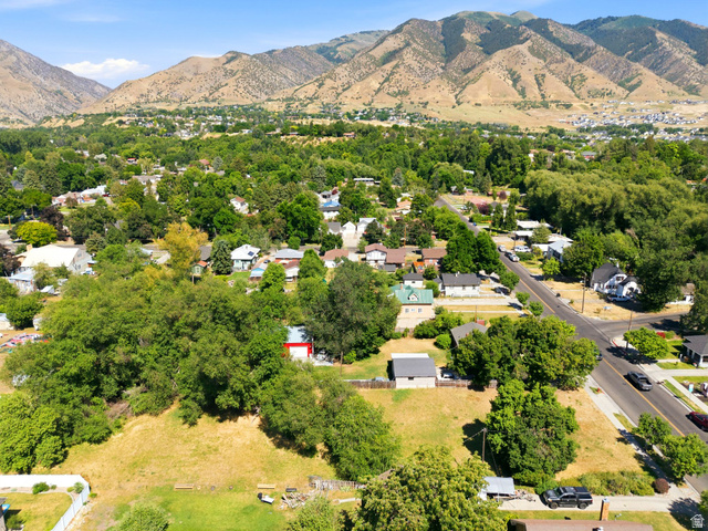 300 East S, Unit 2 Logan, UT 84321 - Photo 5 of 38 Expansive residential area featuring established homes, mature trees, paved roadways, and mountain scenery