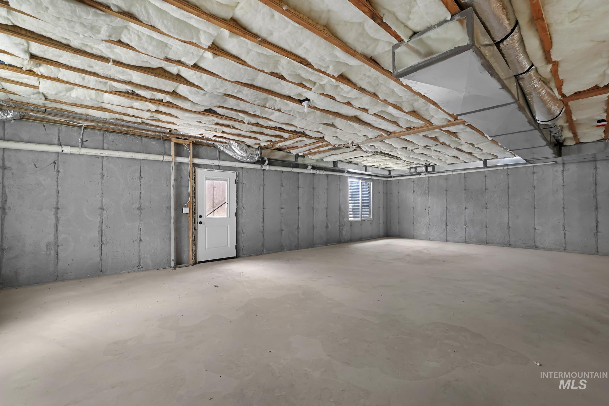 866 Quartz Road Kimberly, ID 83341 - Photo 40 of 48 Spacious unfinished basement offering concrete walls, exposed ceiling insulation, a white exterior door, a basement window, and visible ductwork