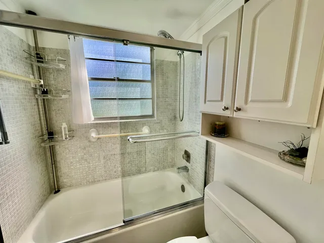 a bathroom with a bathtub and a shower