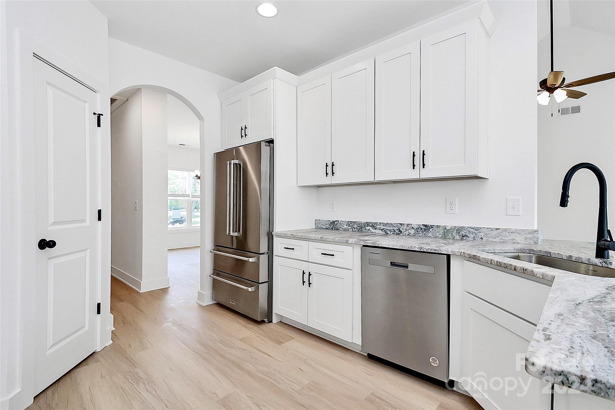 115 Starmount Drive Kings Mountain, NC 28086 - Photo 13 of 39 a kitchen with granite countertop a refrigerator stove and white cabinets