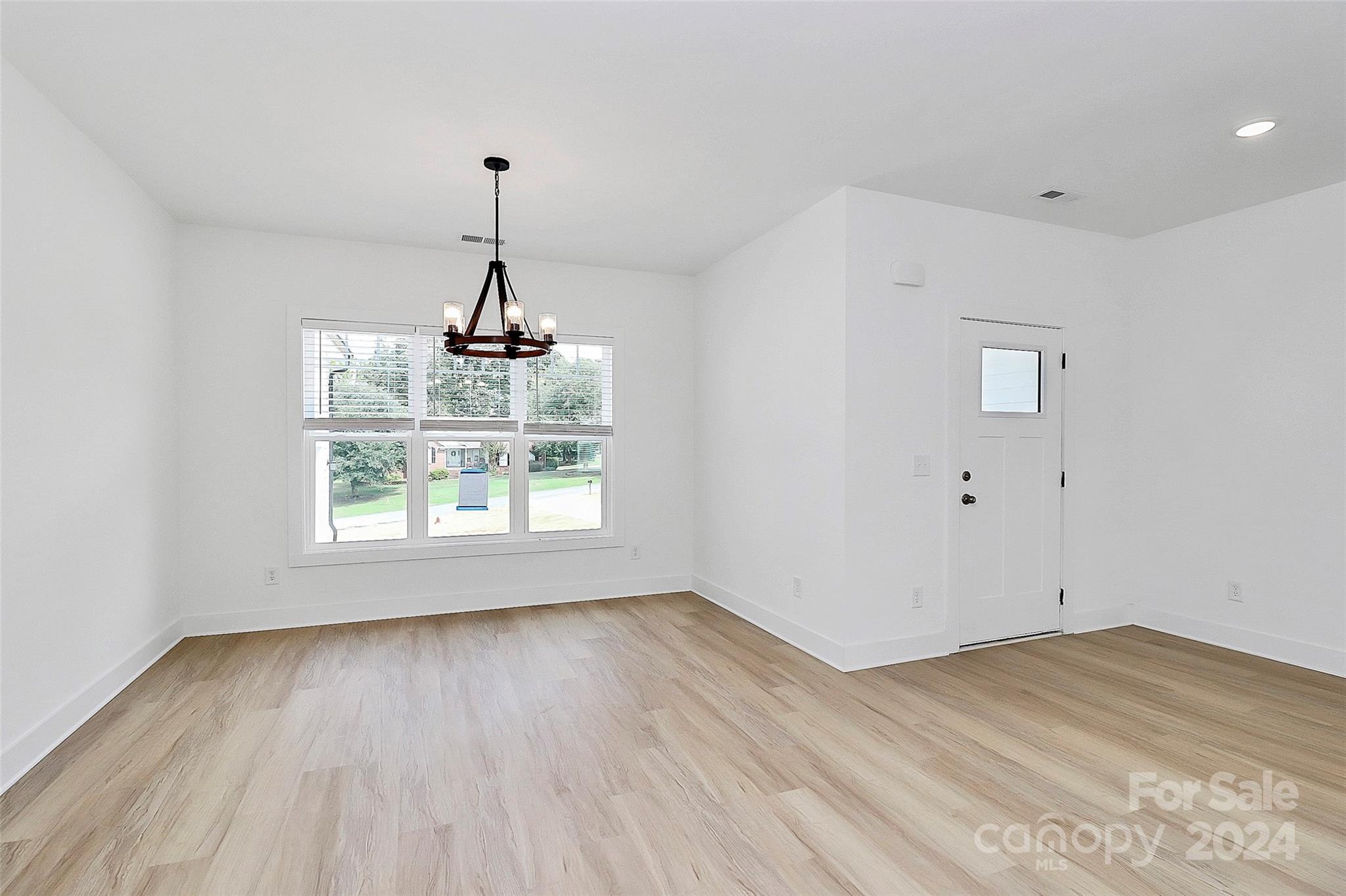 115 Starmount Drive Kings Mountain, NC 28086 - Photo 16 of 39 an empty room with wooden floor cabinet and windows