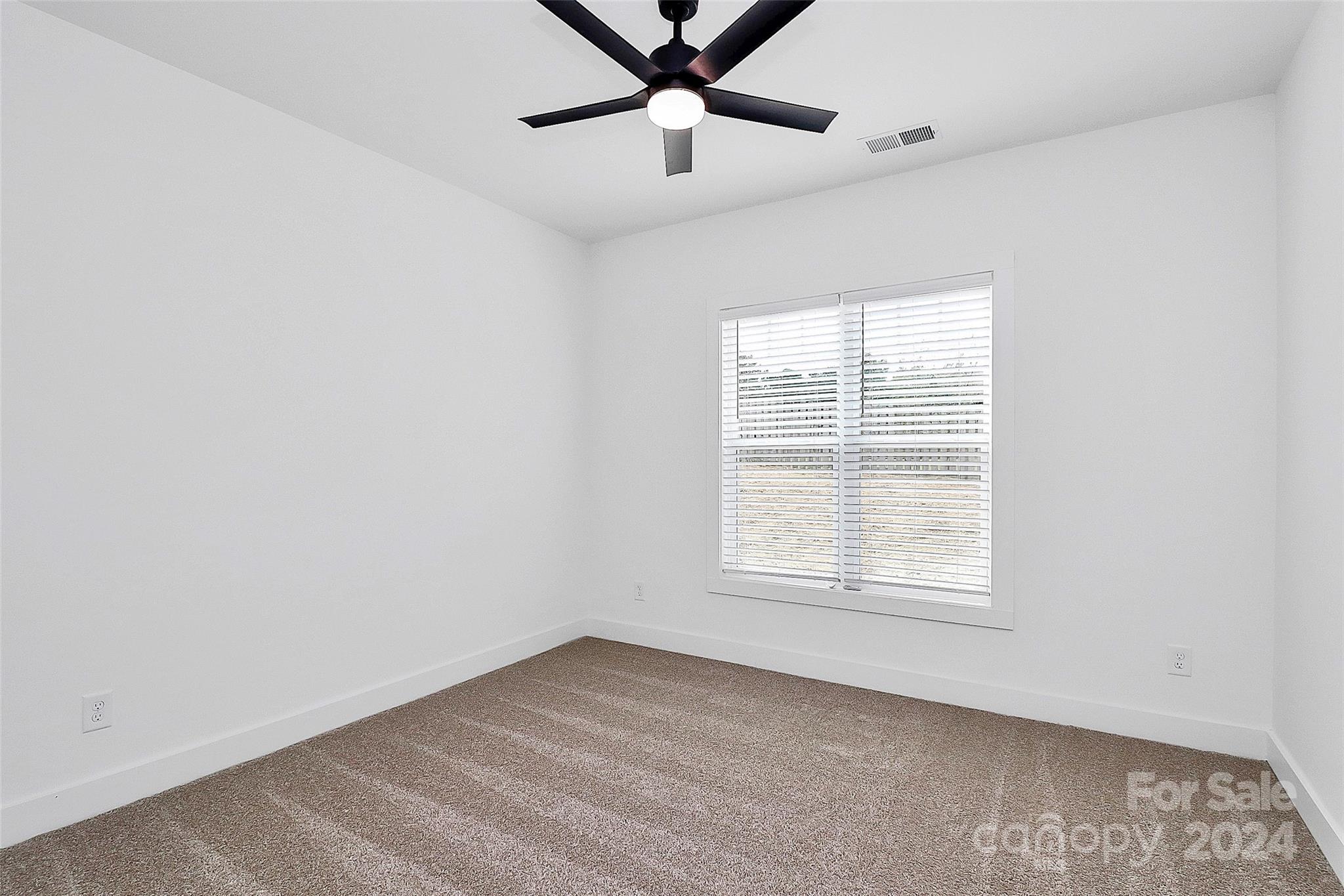 115 Starmount Drive Kings Mountain, NC 28086 - Photo 19 of 39 an empty room with a window and a fan
