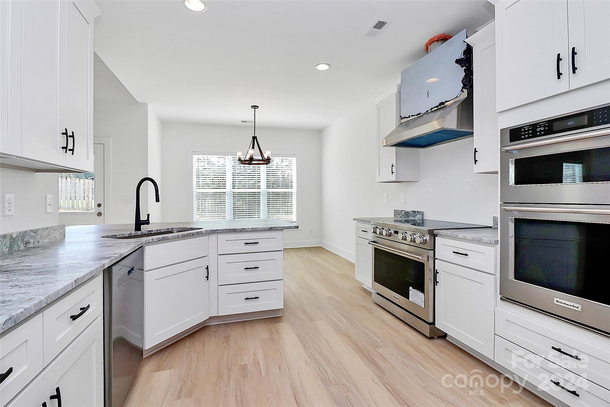 115 Starmount Drive Kings Mountain, NC 28086 - Photo 9 of 39 a kitchen with granite countertop white cabinets and white appliances
