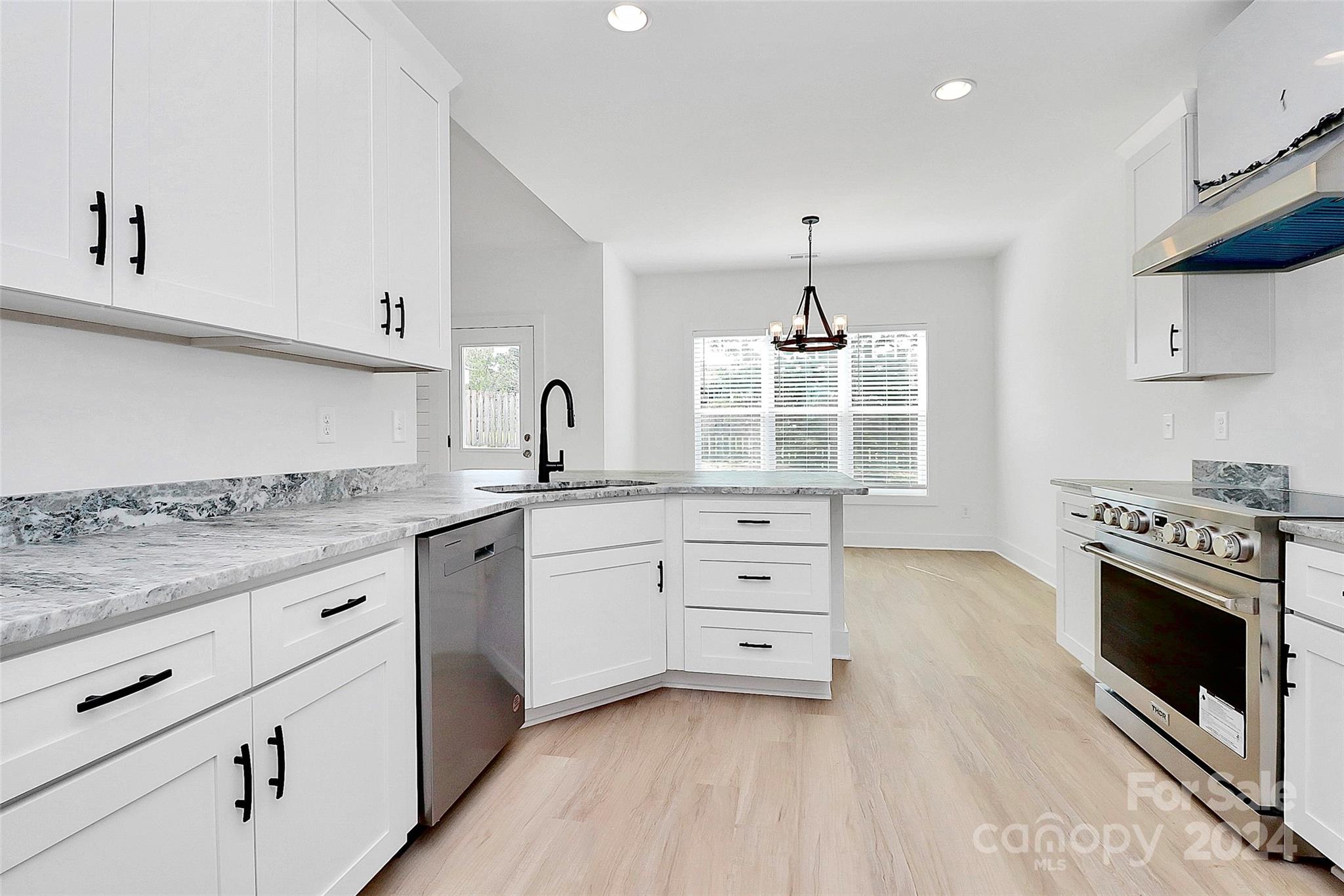 115 Starmount Drive Kings Mountain, NC 28086 - Photo 10 of 39 a kitchen with granite countertop a stove cabinets and wooden floor