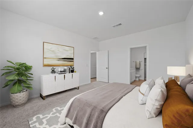 a bedroom with a bed and a potted plant