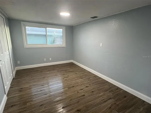 wooden floor in an empty room with a window