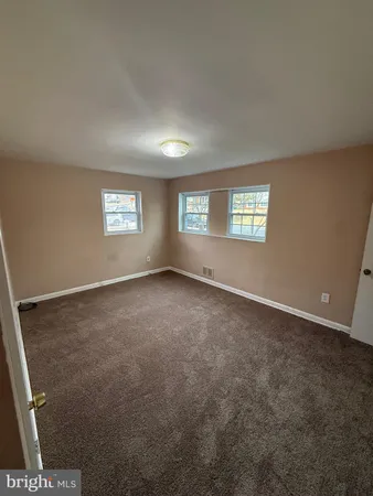 a view of an empty room with windows