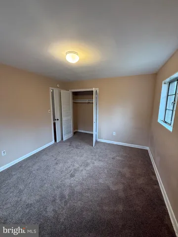 an empty room with a empty space and windows