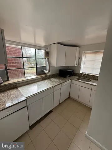 a kitchen with stainless steel appliances granite countertop a sink and cabinets