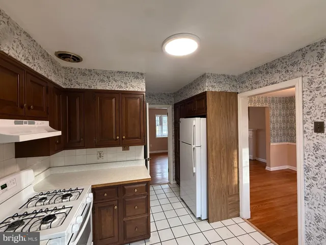 a kitchen with a stove and a refrigerator