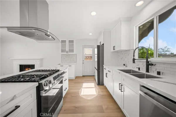 a kitchen with stainless steel appliances a stove and a refrigerator