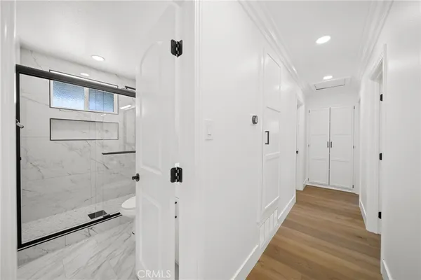 a bathroom with a toilet and a shower