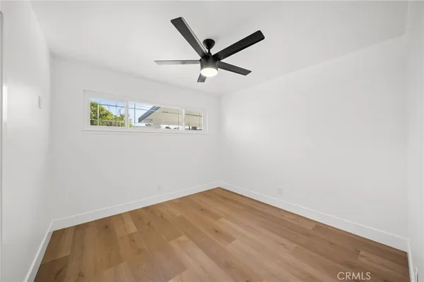 a view of a room with wooden floor