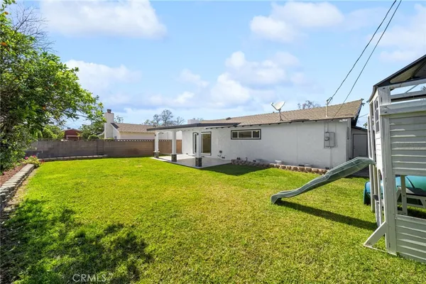 a swimming pool with outdoor seating and yard