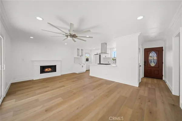 a view of an empty room with a fireplace and a window